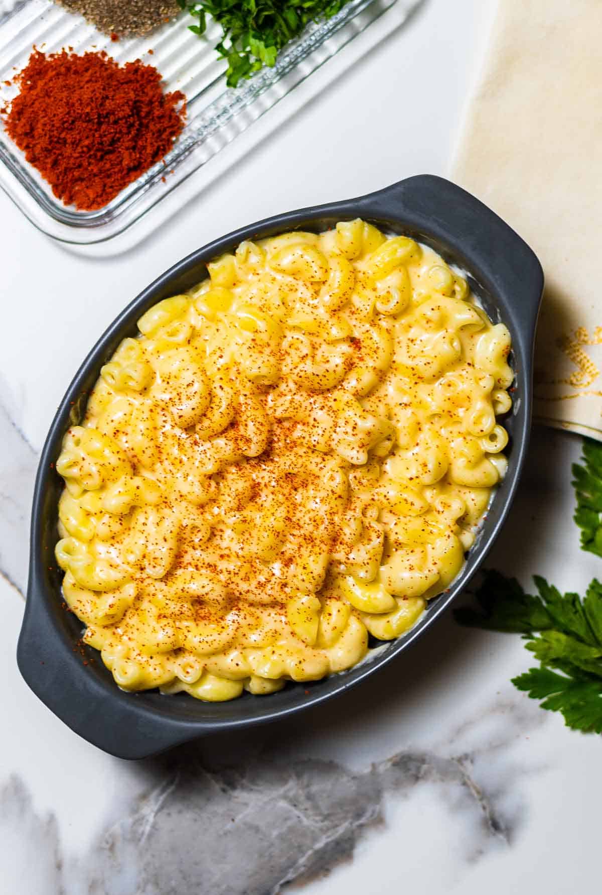 close-up of creamy stovetop gouda mac and cheese in a grey baking dish