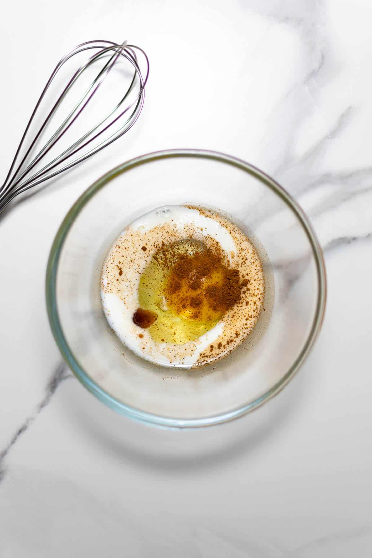 a bowl of glass containing french toast batter