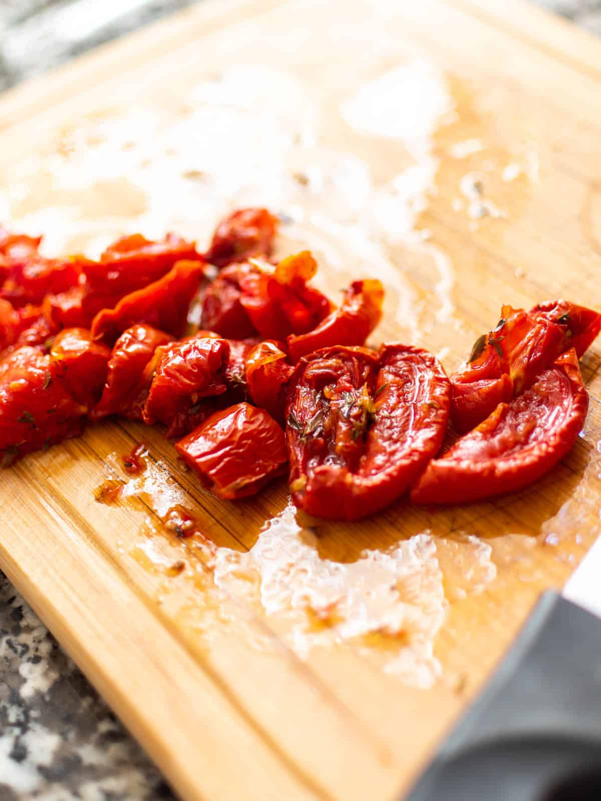 sun-dried tomatoes diced on a wood board