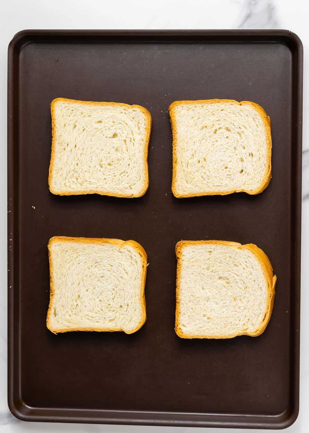 bread slices on a baking sheet.