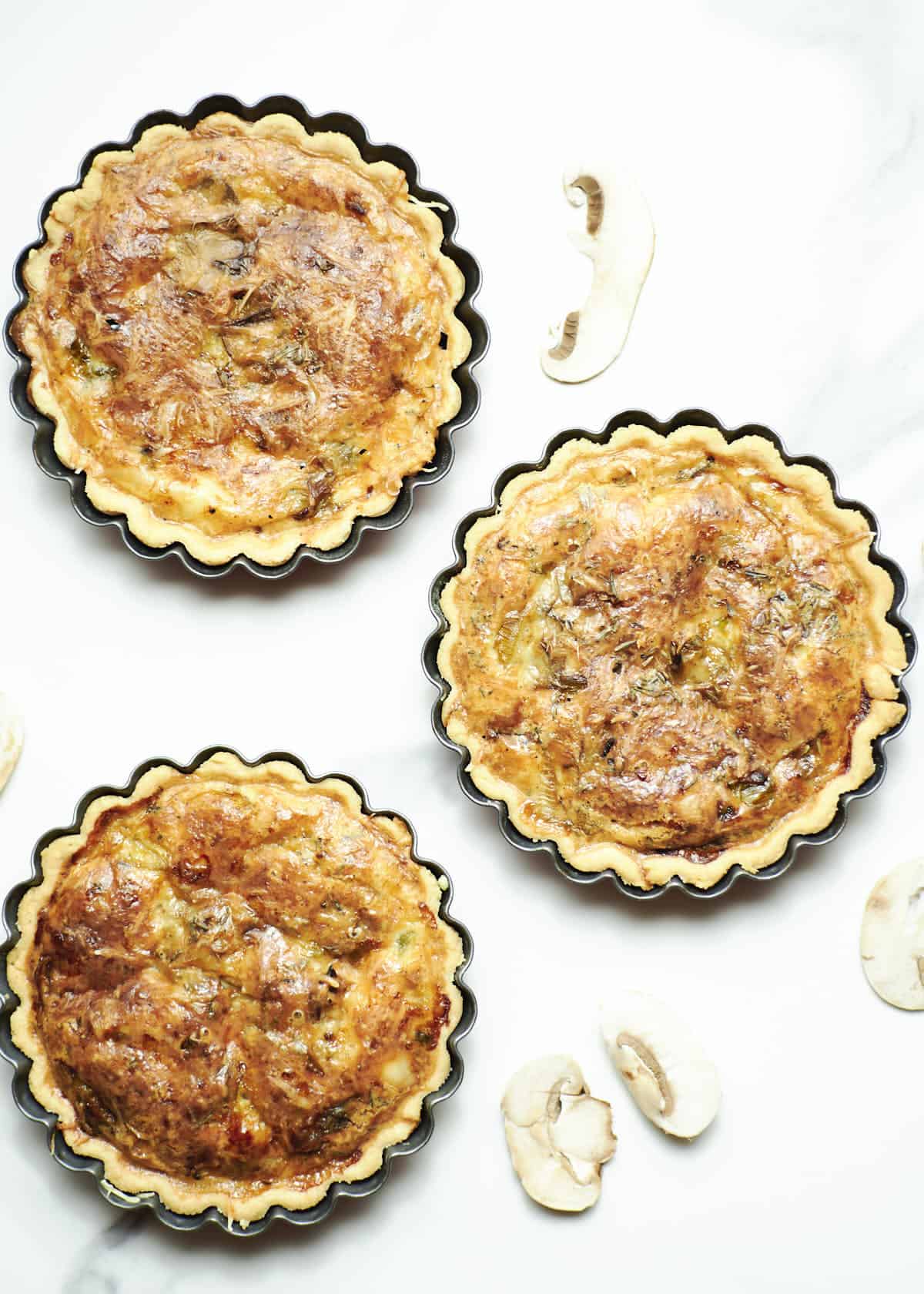 overhead shot of mini quiche on white surface