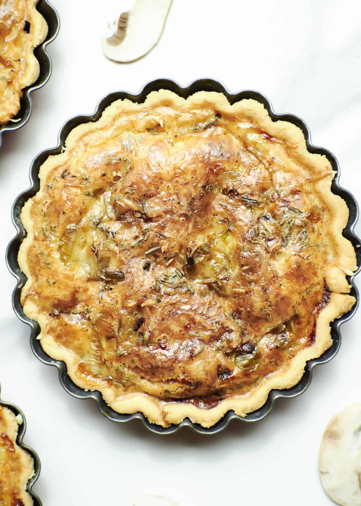 close-up shot of mini leek quiche with mushrooms