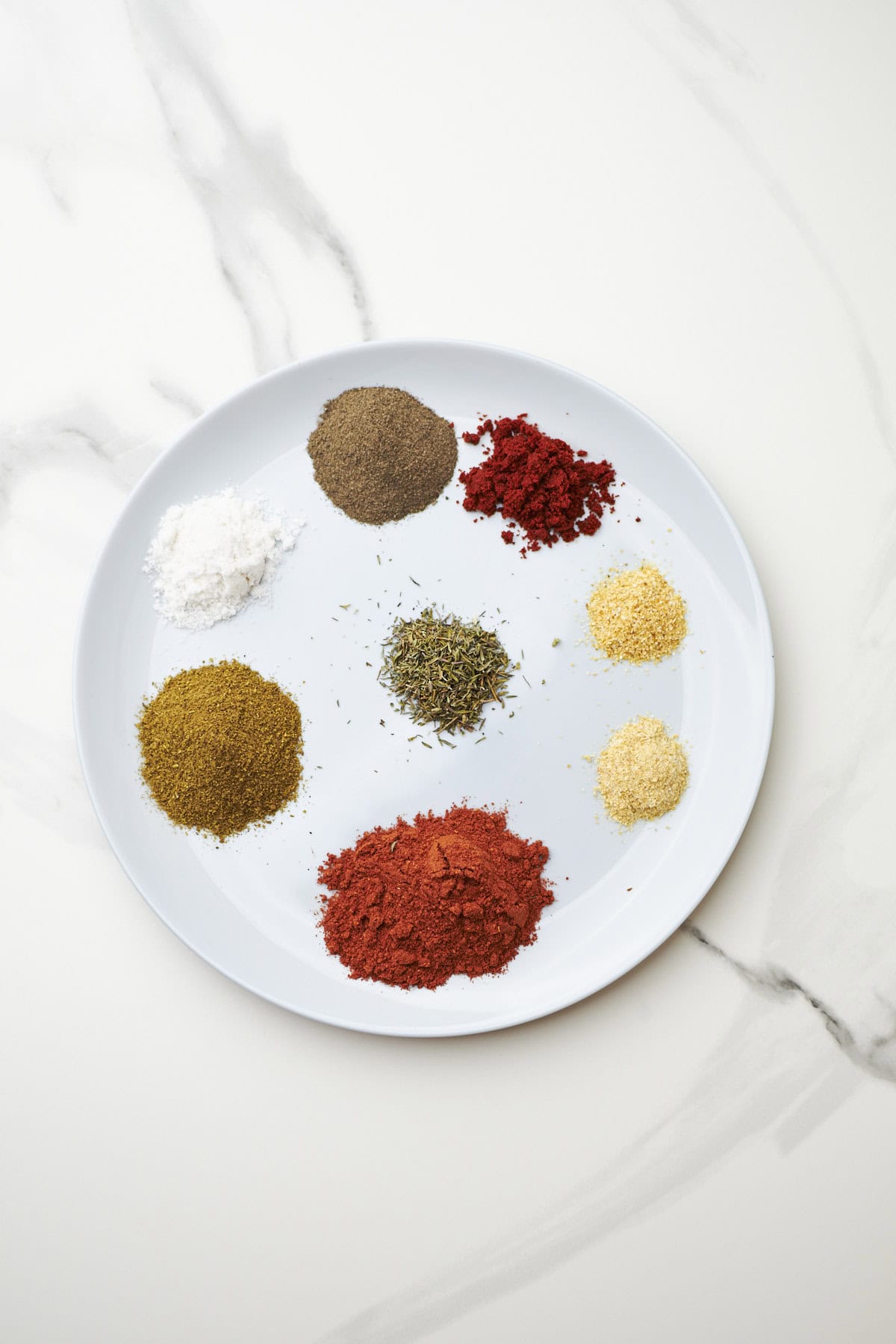 closeup of spices for chicken taco seasoning in a dish.