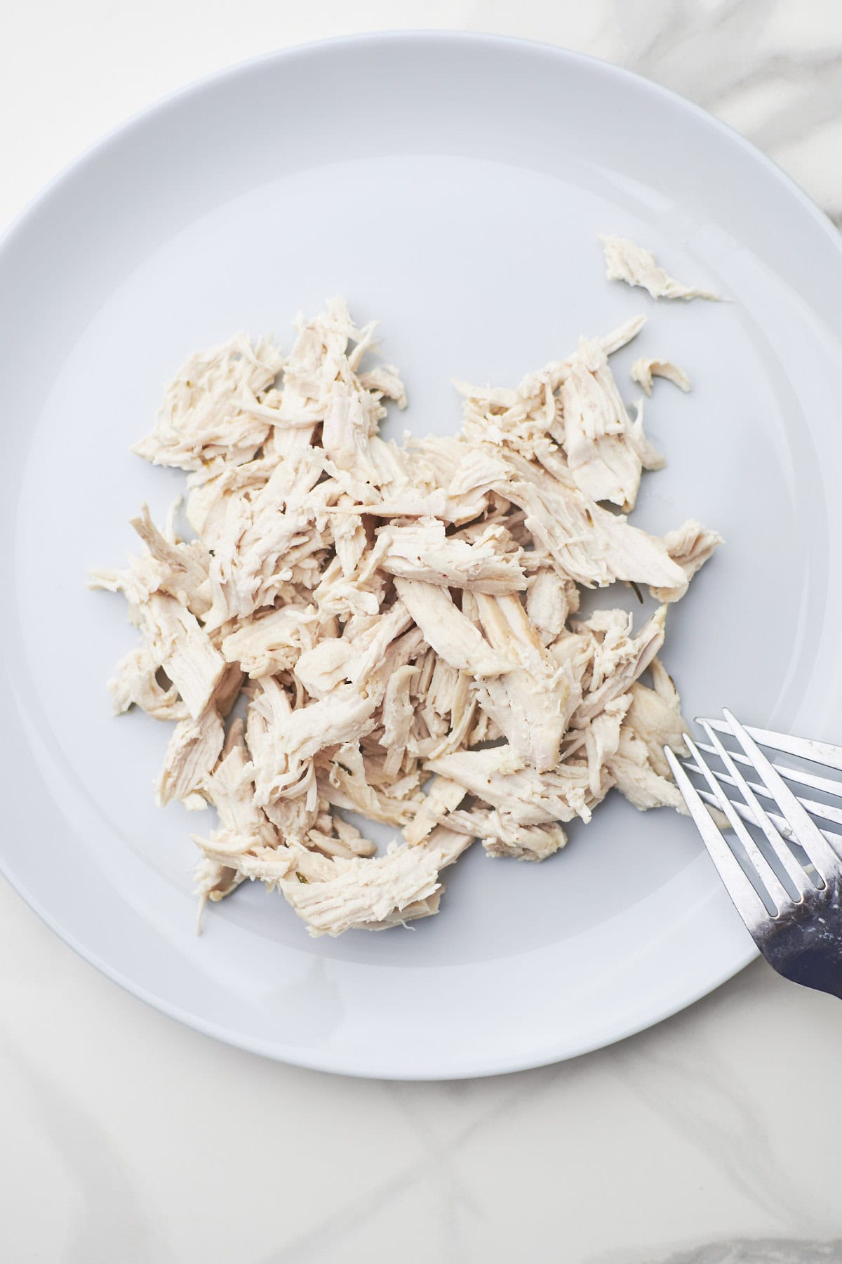 shredded chicken on cutting board.