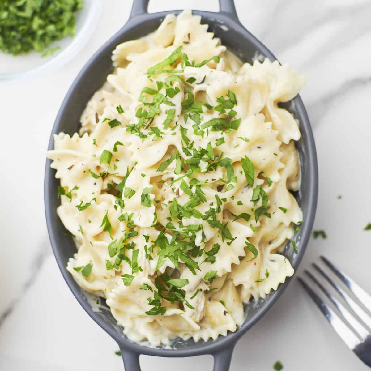 buffalo wild wings garlic parmesan chicken pasta in serving bowl with fork.