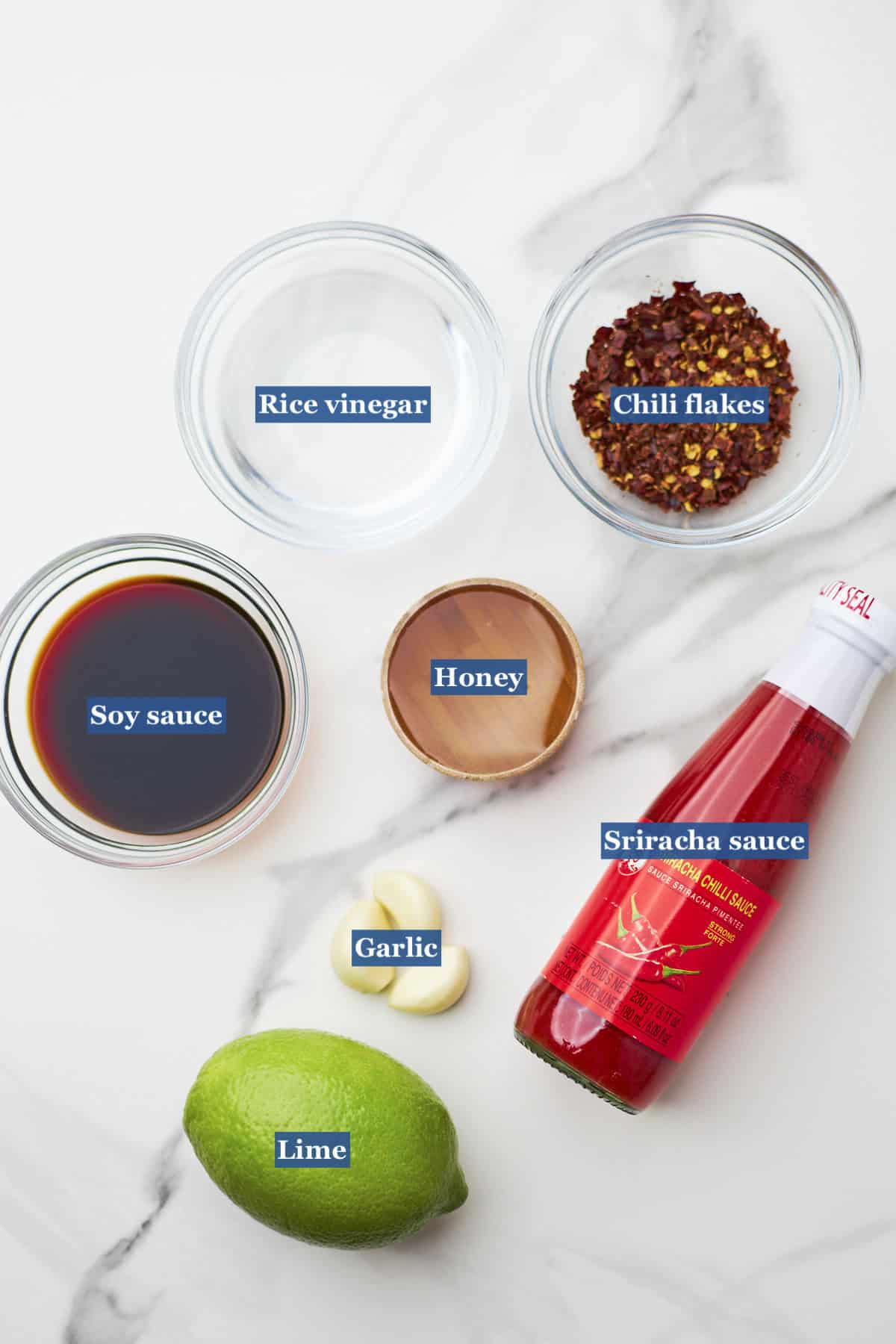 ingredients for honey sriracha sauce on countertop.