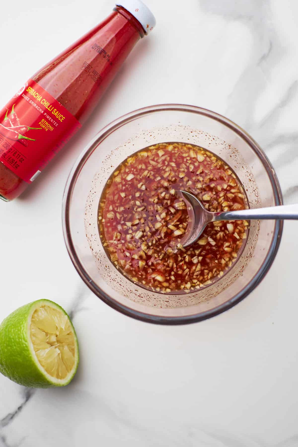 sriracha honey sauce in bowl on countertop.