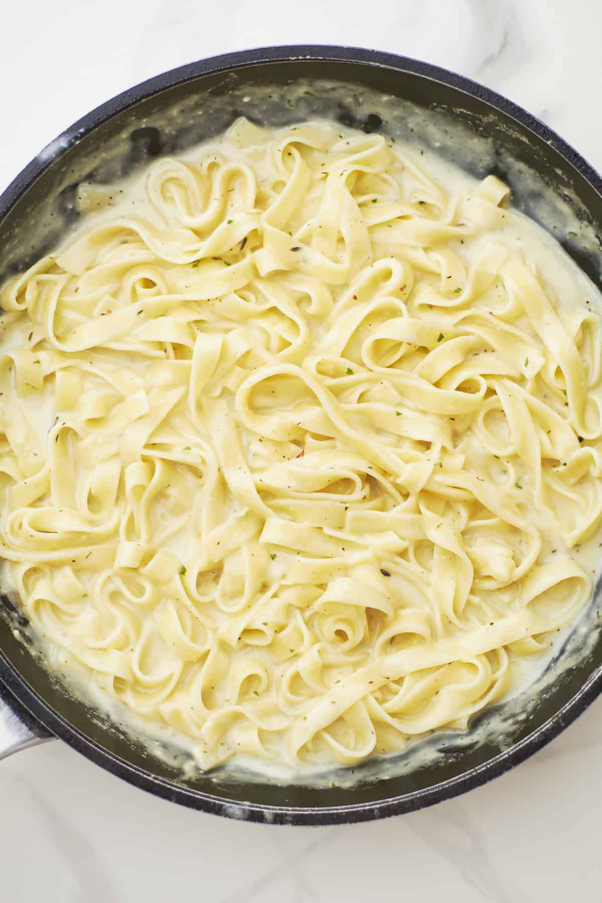 Overhead shot of a chicken Alfredo tagliatelle pasta.