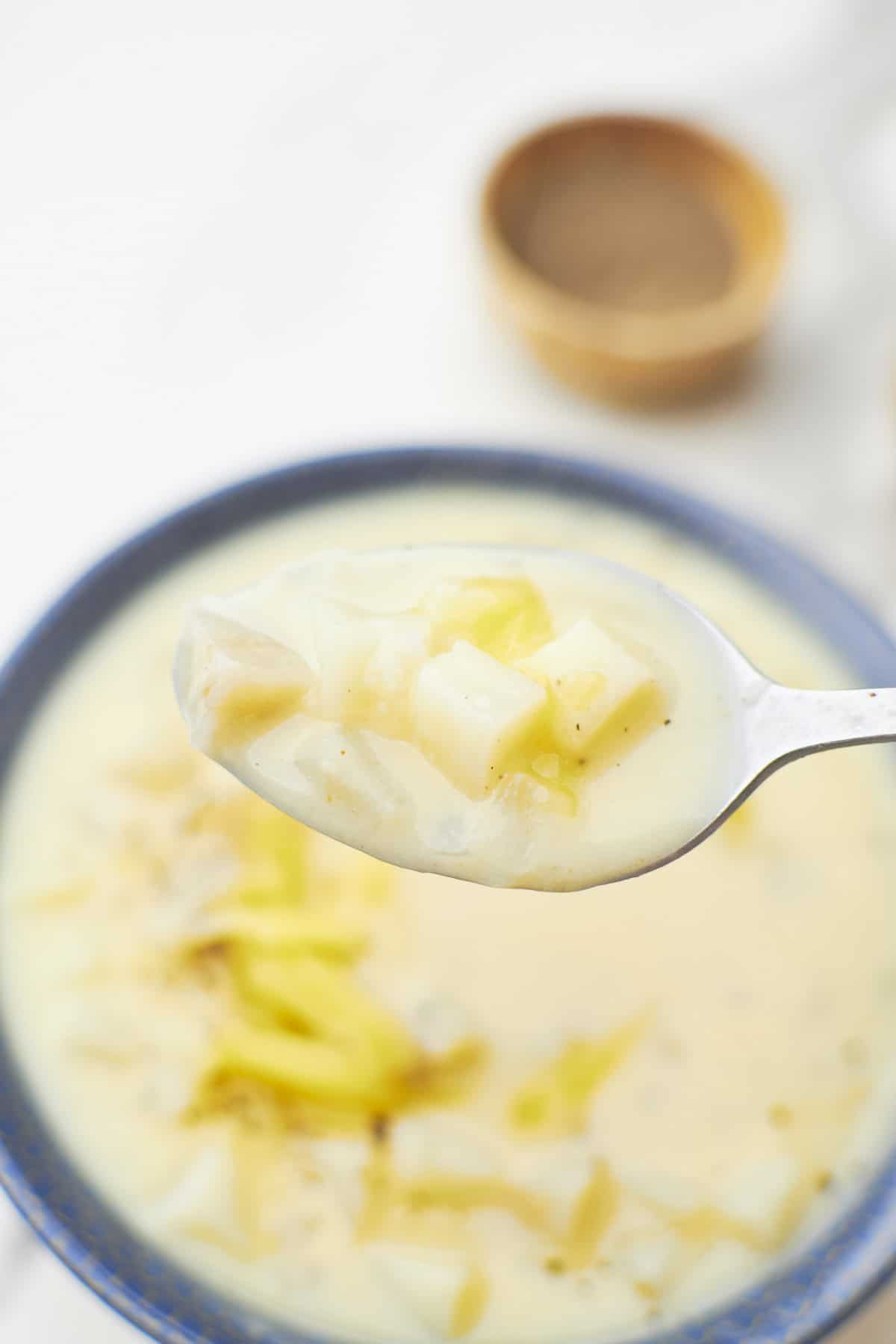 A spoon inside the soup bowl.