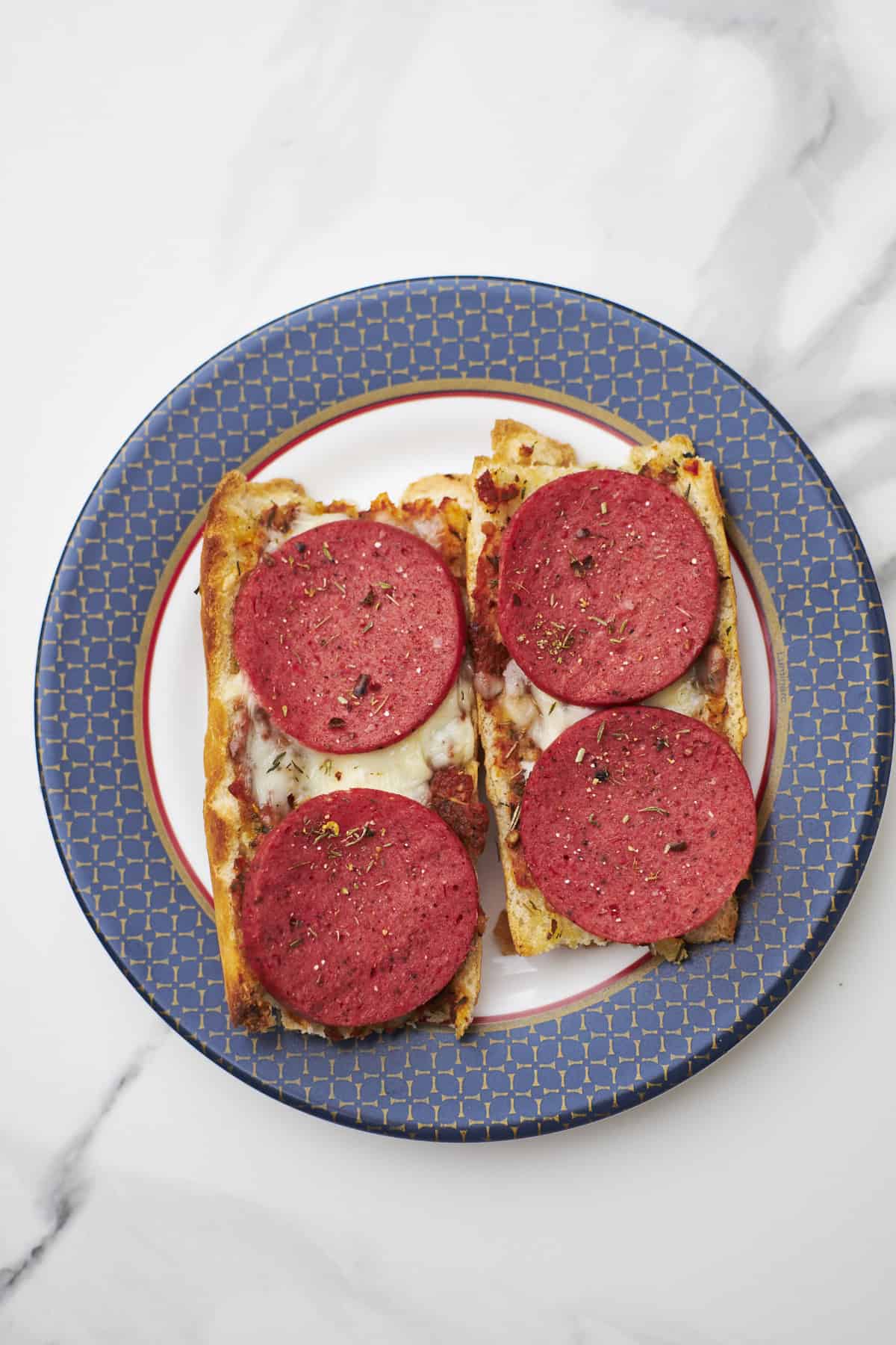 french bread pizza made in the air fryer, on a white surface.