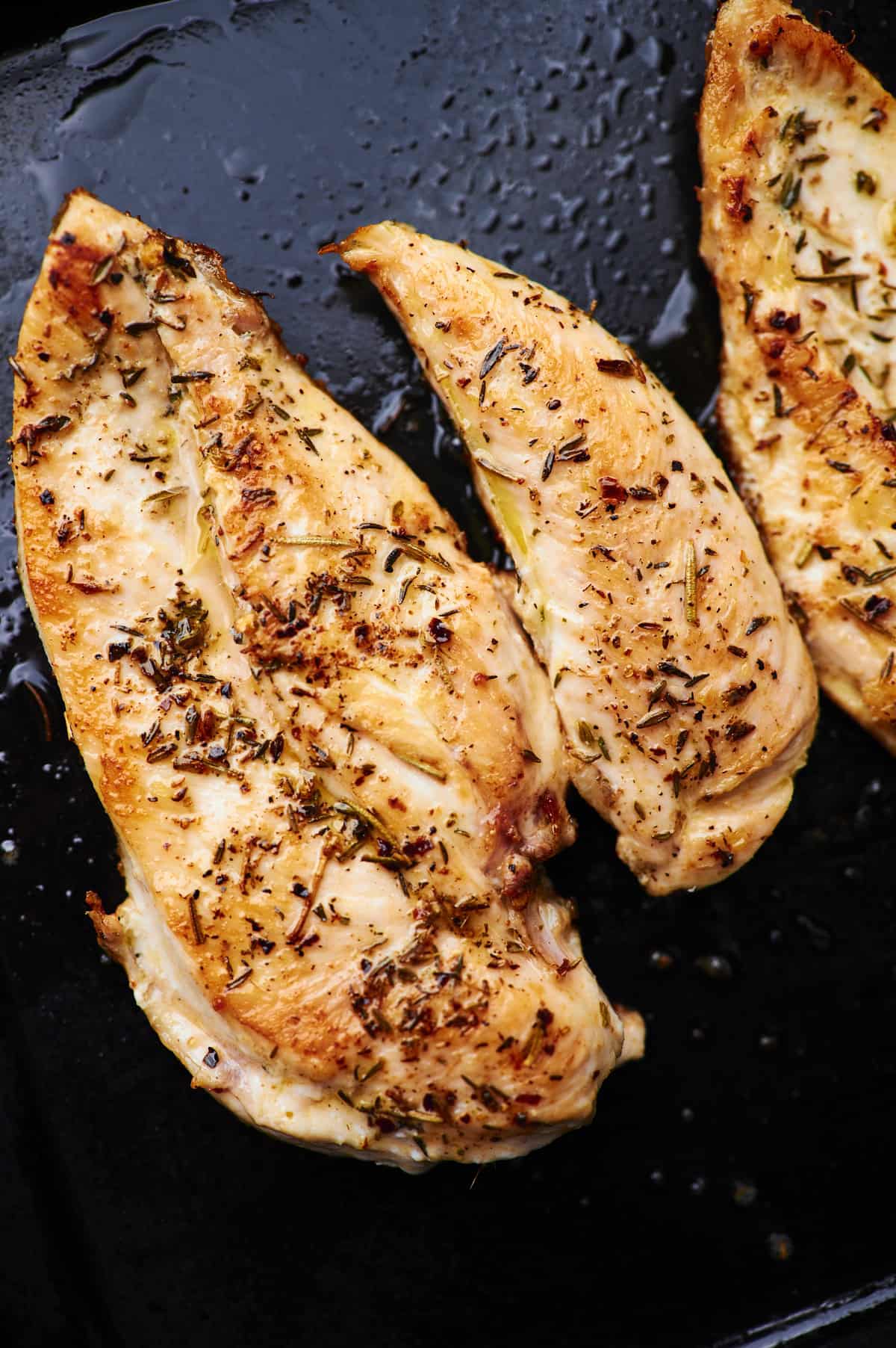 golden brown seared chicken on blackstone griddle.