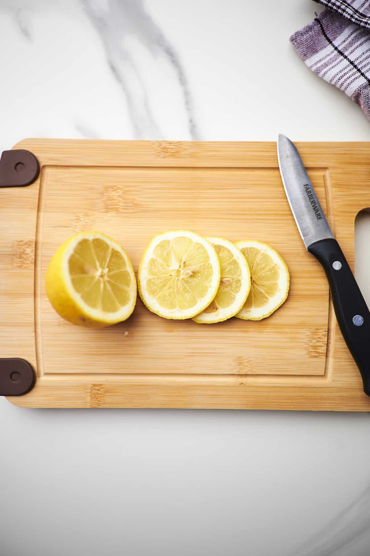 sliced lemon on cutting board.