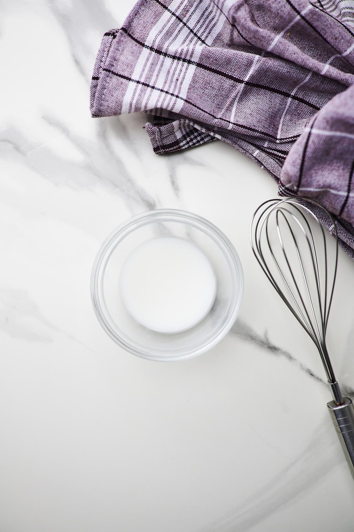 Whisking reserved pasta water and cornstarch.