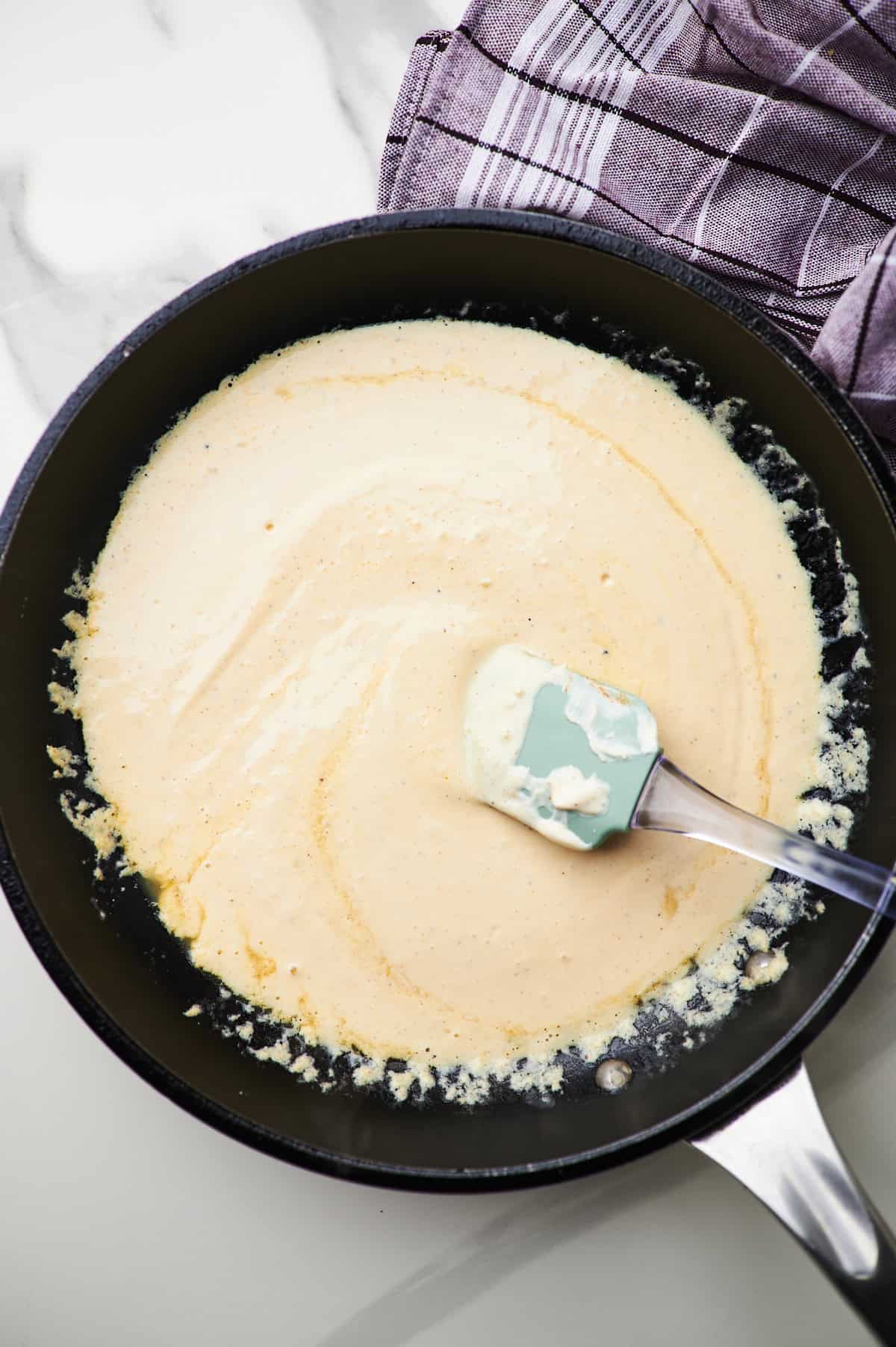 Cooking cottage cheese pasta sauce in a pan.