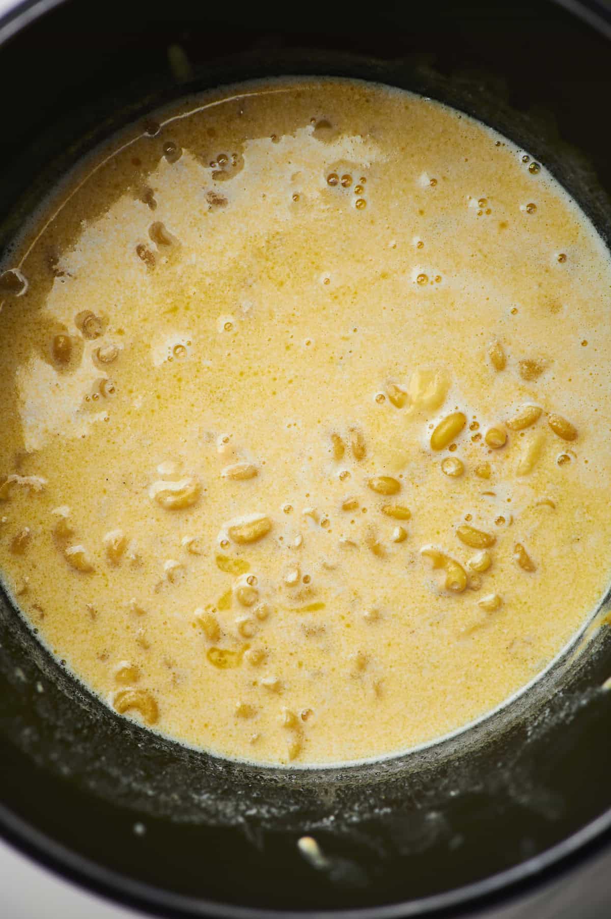 Overhead view of slow cooker mac and cheese ready to be cooked