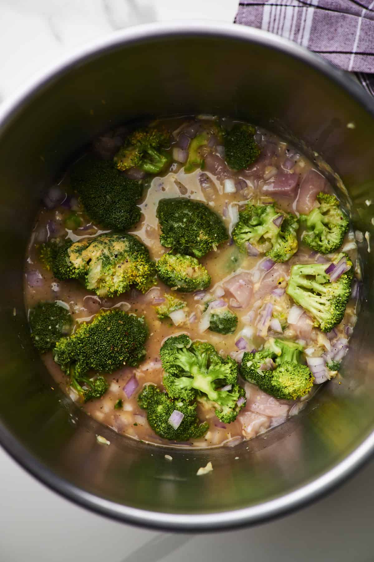 ingredients for chicken broccoli and rice casserole in crock pot.