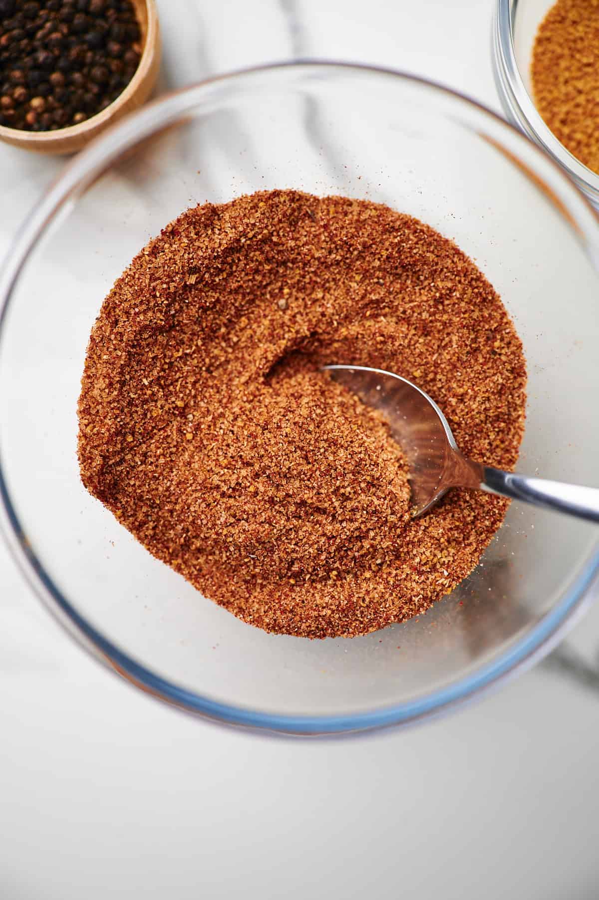 Overhead shot of a glass bowl filled with rib rub seasoning.