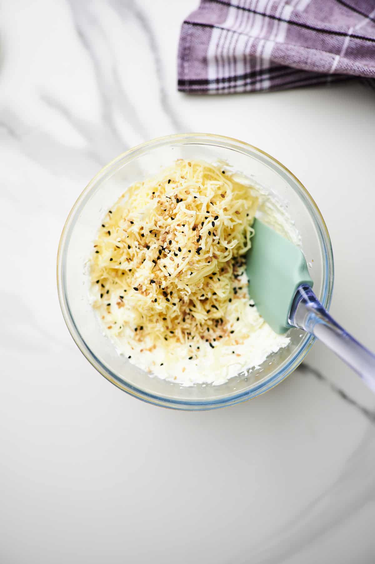 cream cheese, shredded cheddar cheese, and bagel seasoning in a mixing bowl