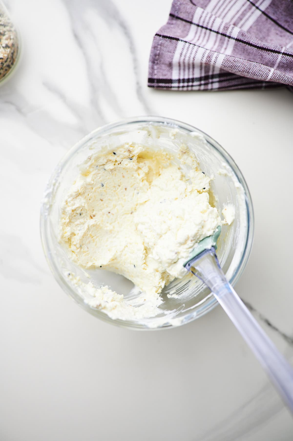 cream cheese, shredded cheddar cheese, and bagel seasoning combined in a mixing bowl