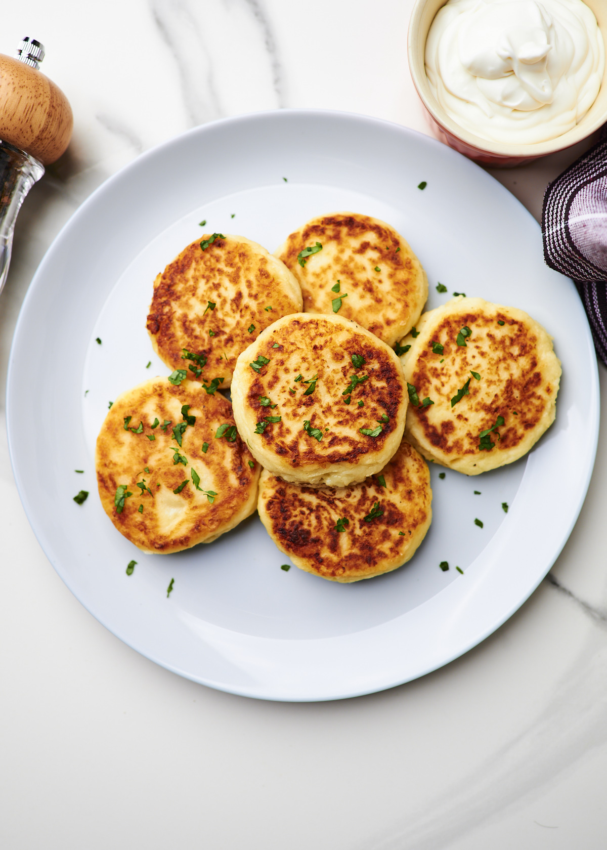 leftover mashed potato patties on a grey plate with parsley