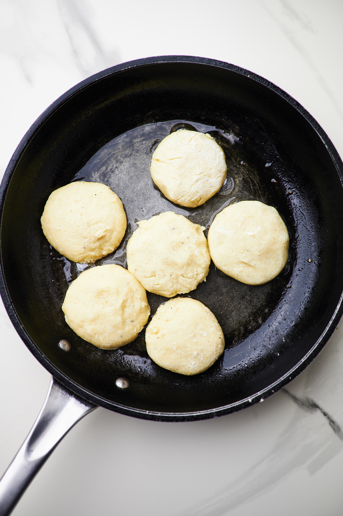 fry potato cakes in frying pan