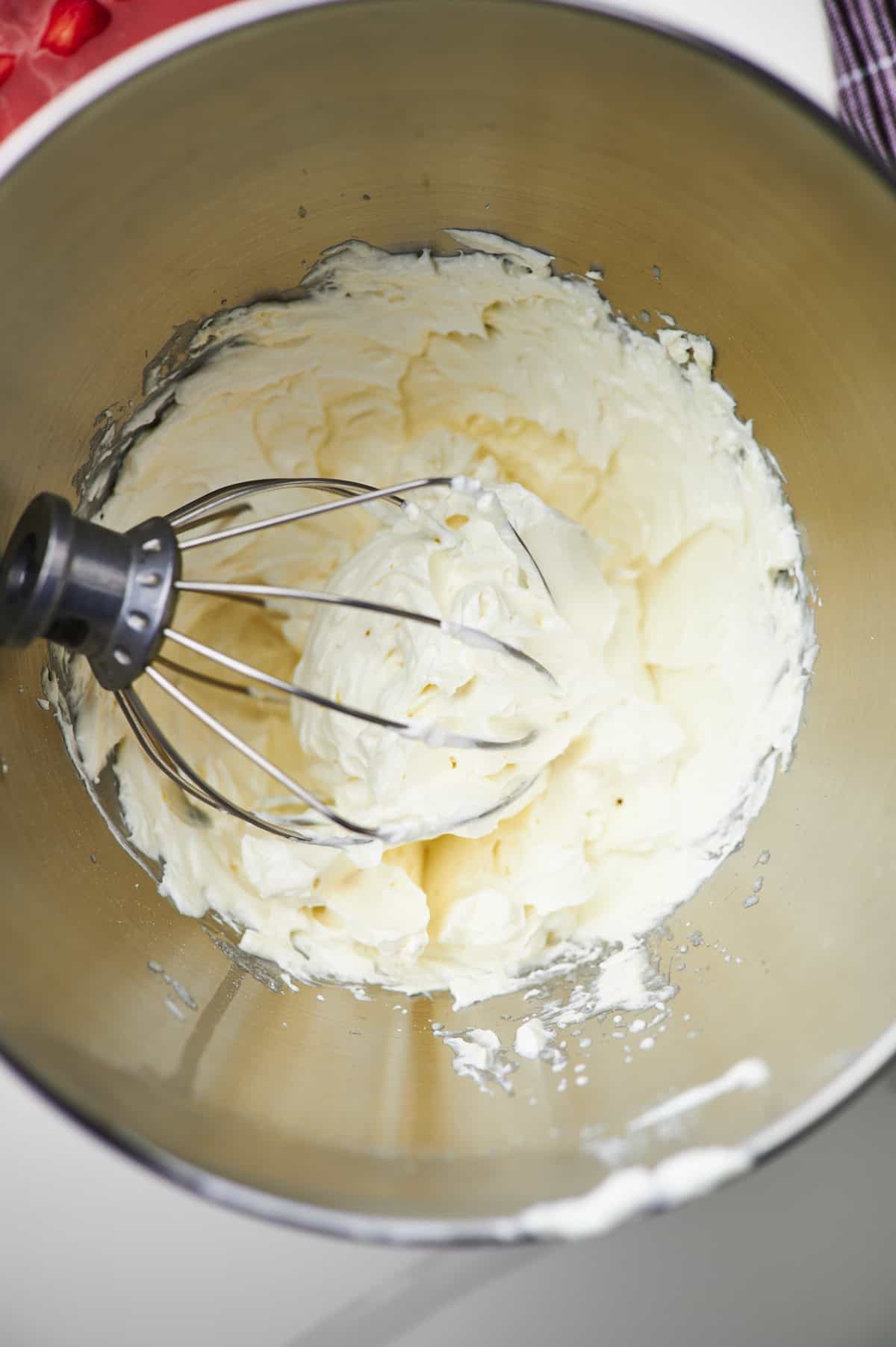 cream cream cheese, vanilla and sugar with electric mixer in mixing bowl