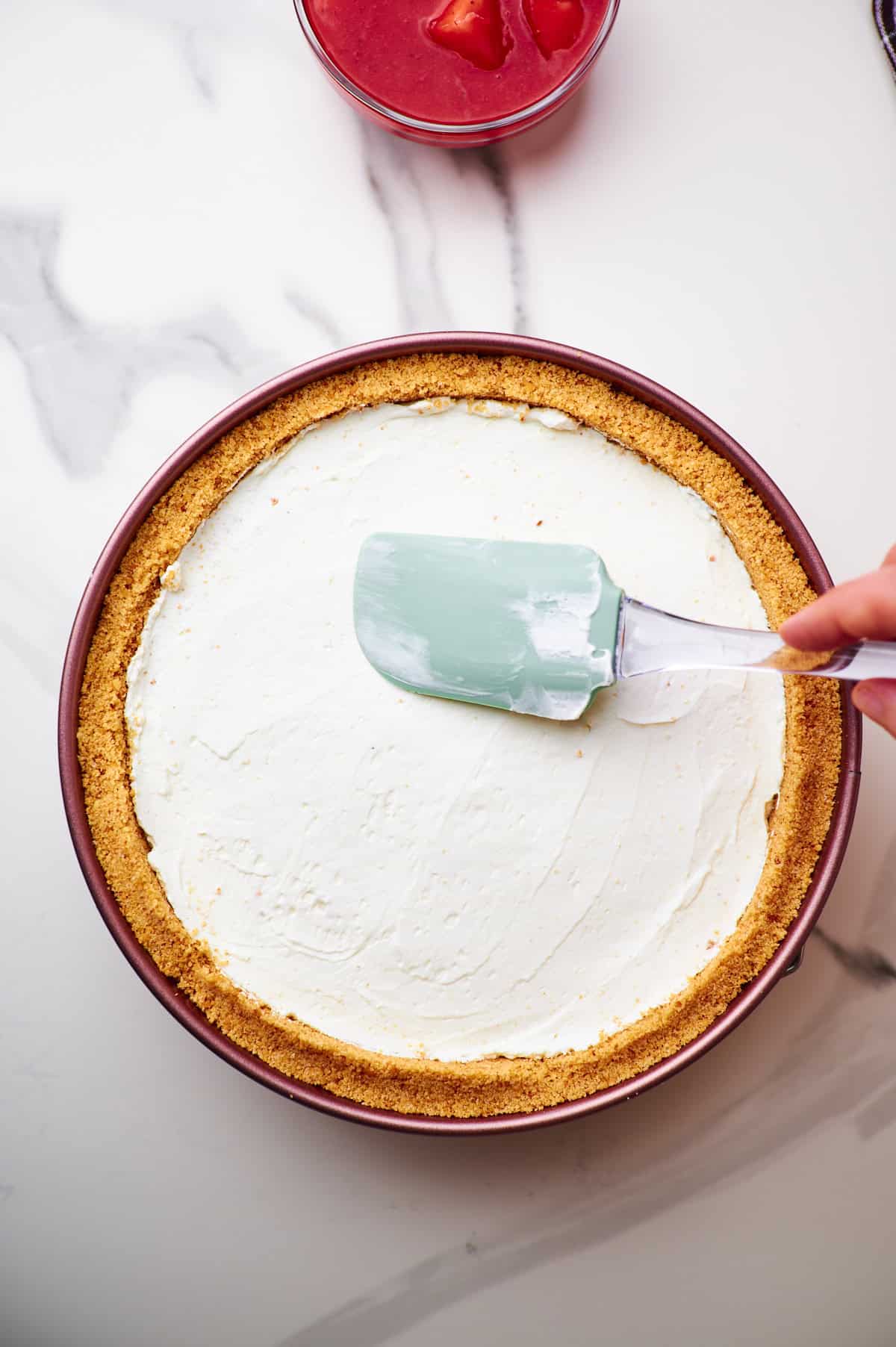 smooth cheesecake filling in graham cracker pie crust