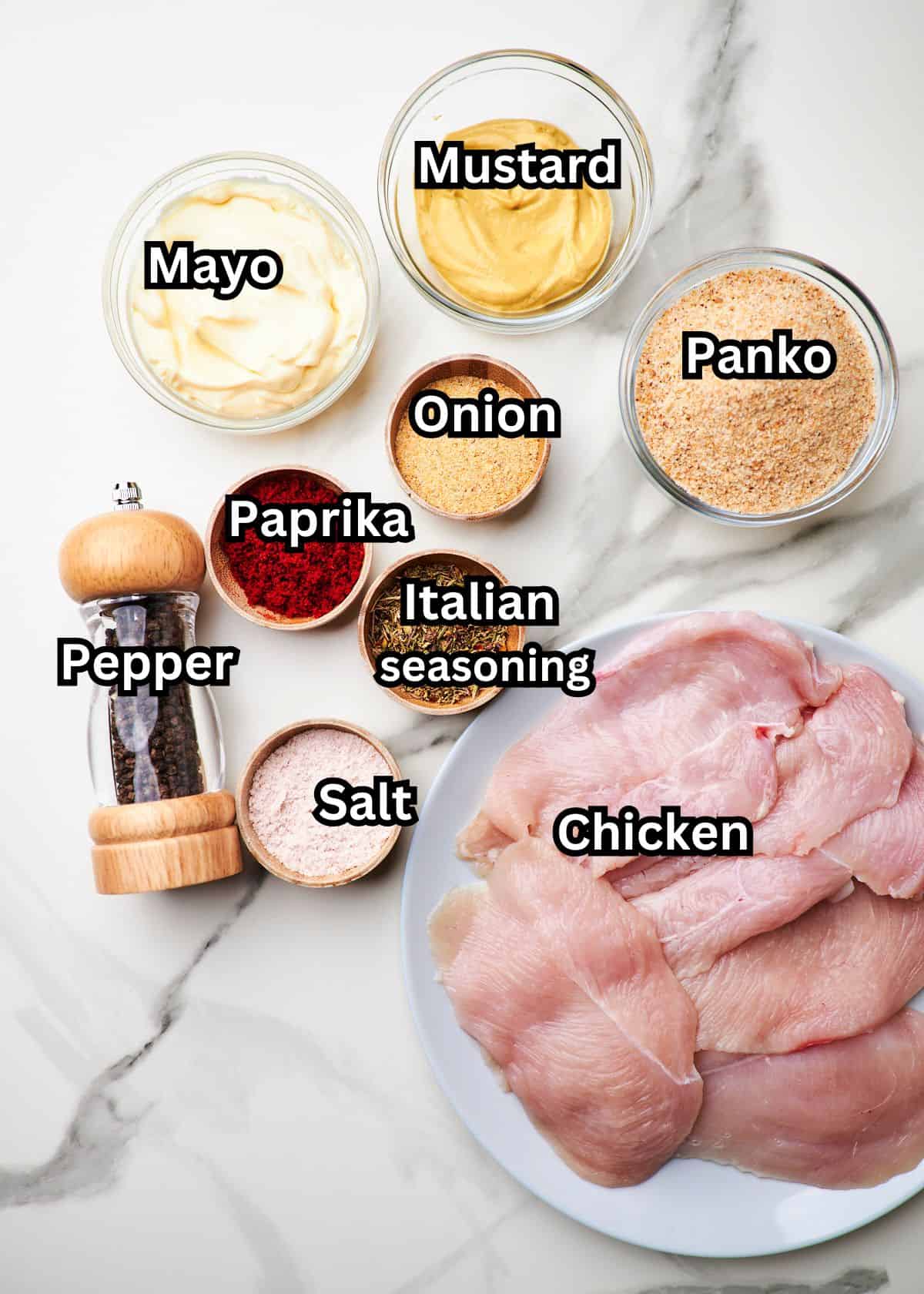 White marble counter top with bowls of ingredients to make Panko chicken.