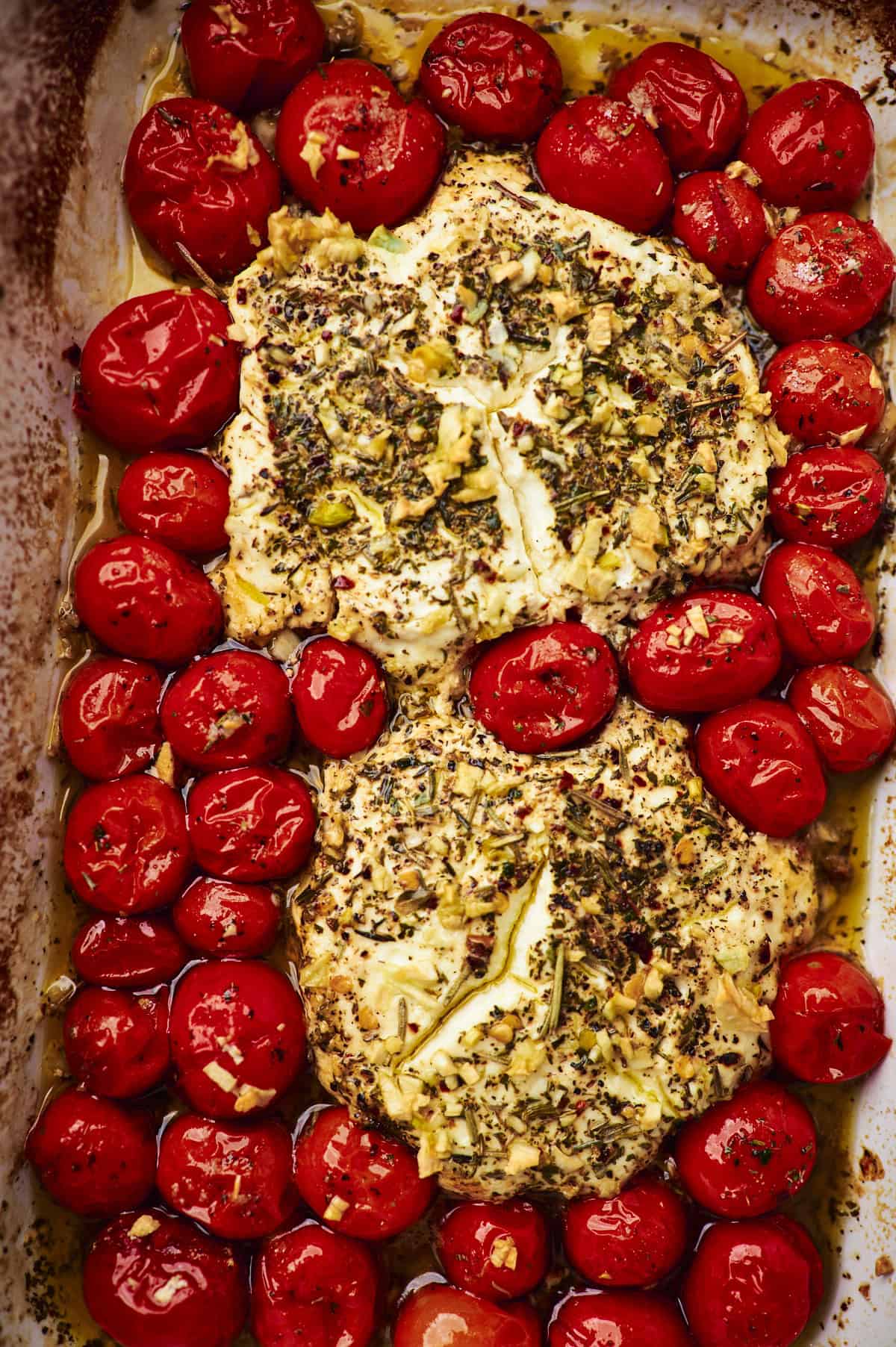 process shot showing the 2 rounds of boursin cheese and tomatoes after baking, before stirring into a sauce.