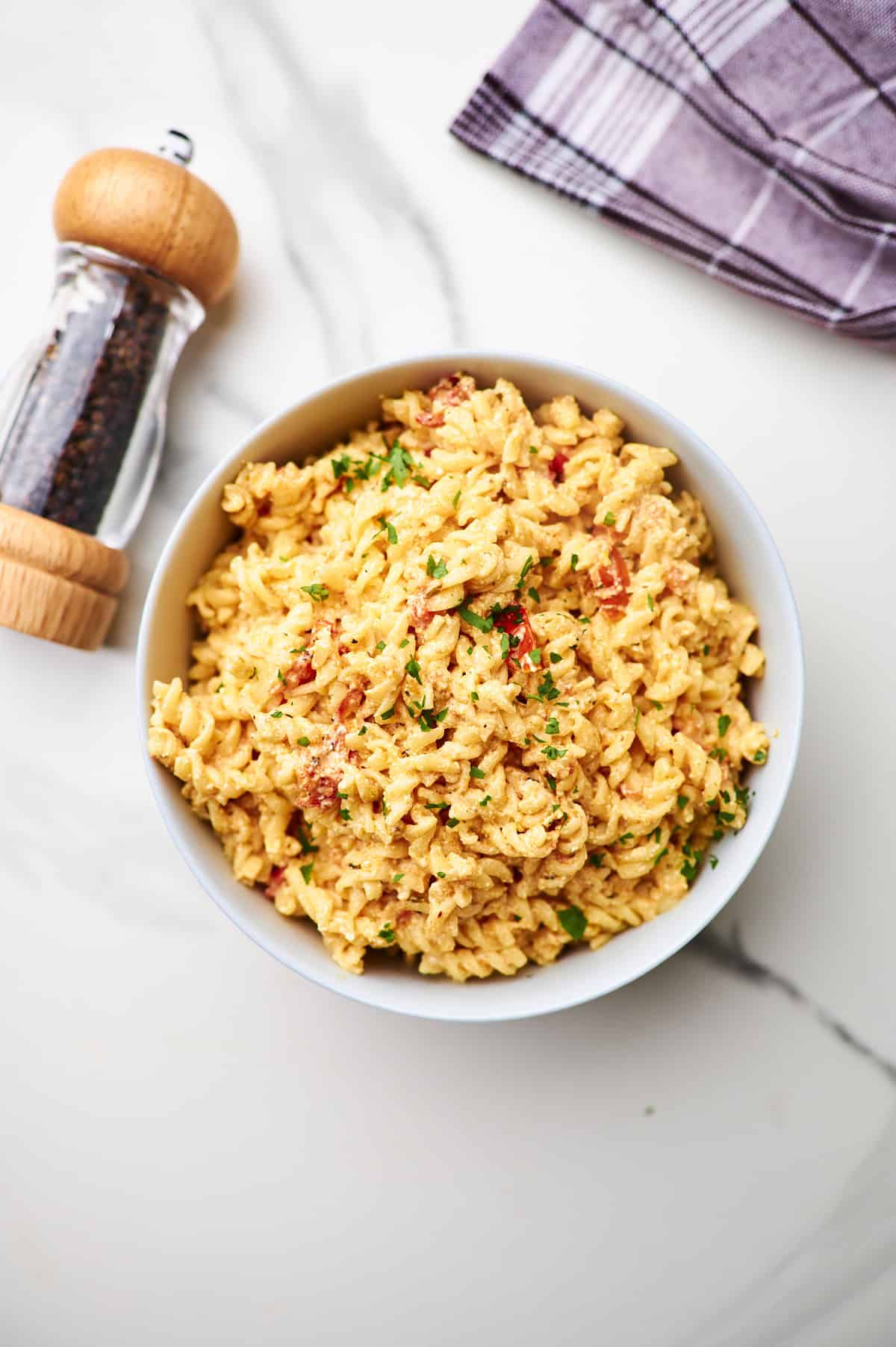 flat lay shot of a bowl of pasta with boursin tomato sauce.