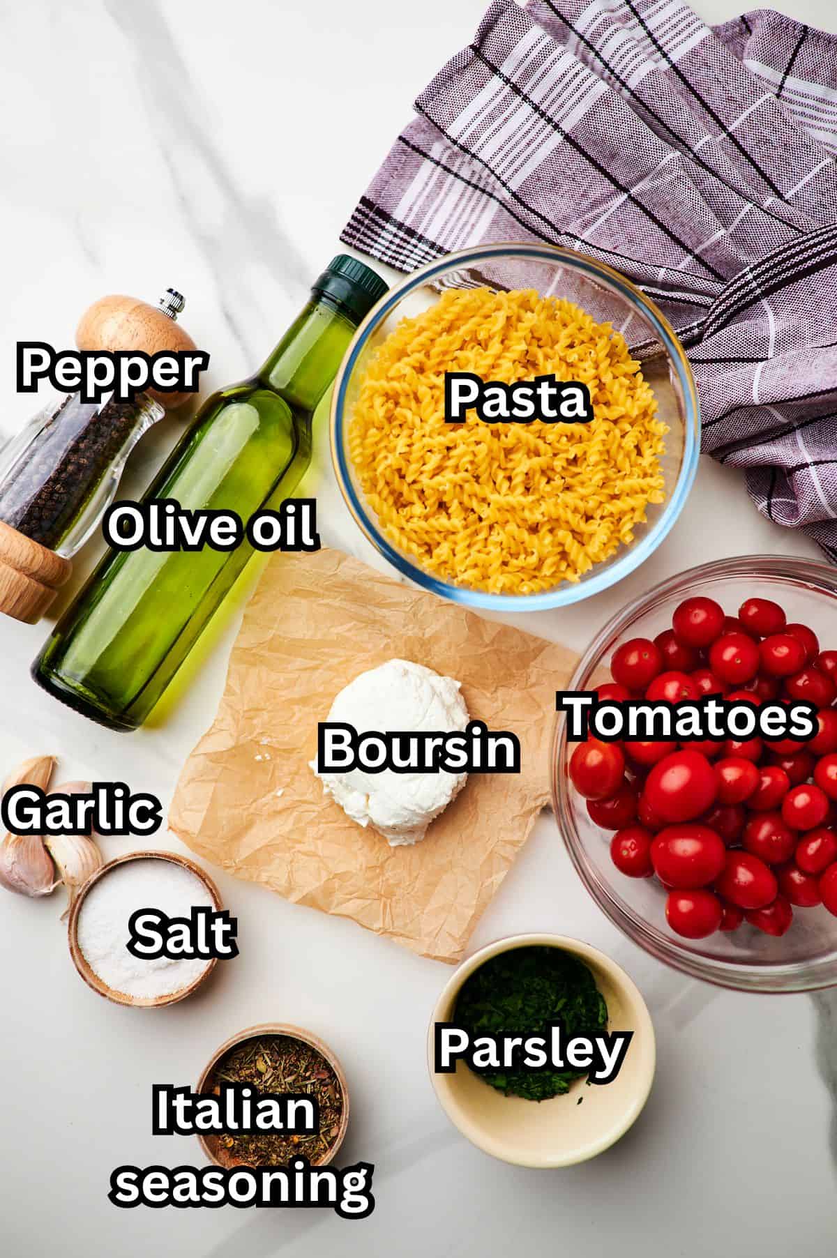 flat lay shot of the ingredients needed to make boursin pasta measured out into bowls on a white table.