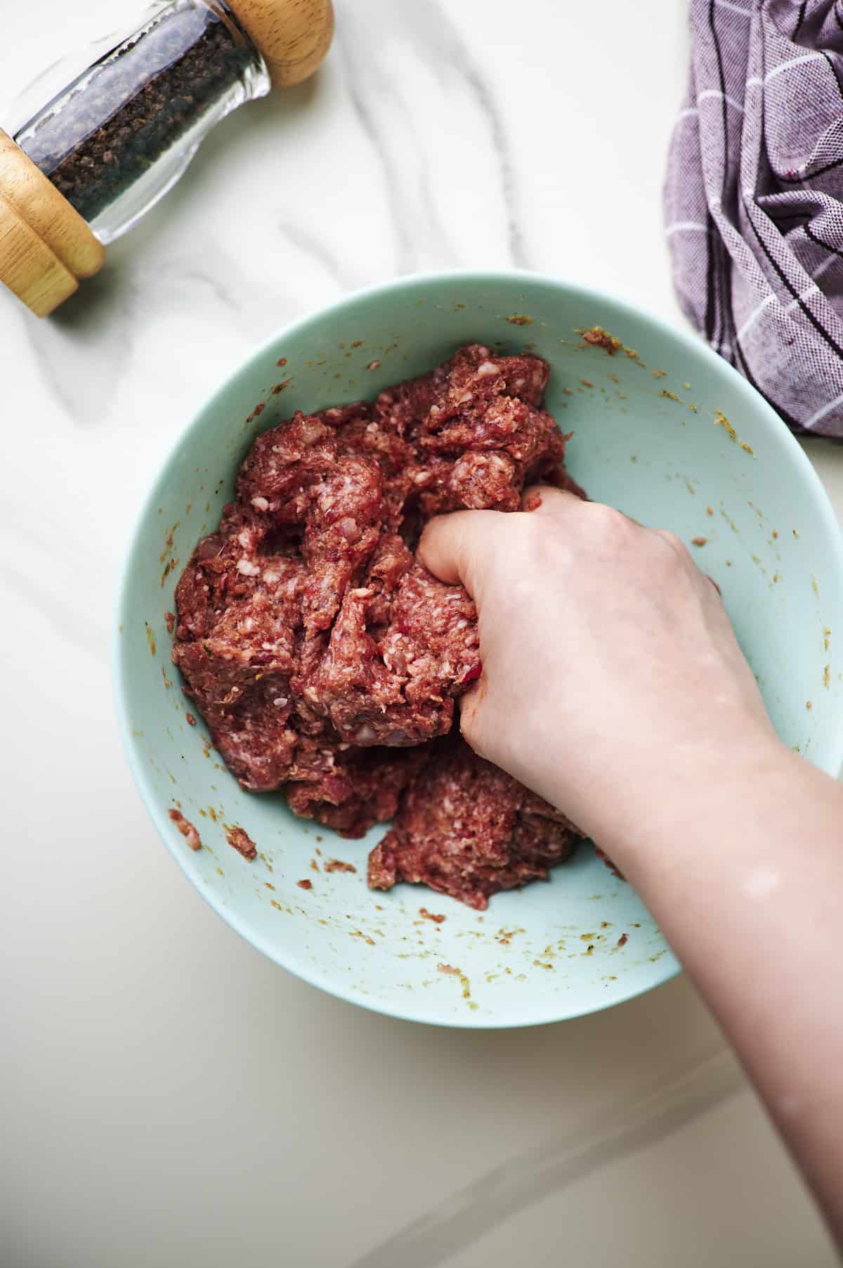 mix meatloaf mixture with hand in large mixing bowl.