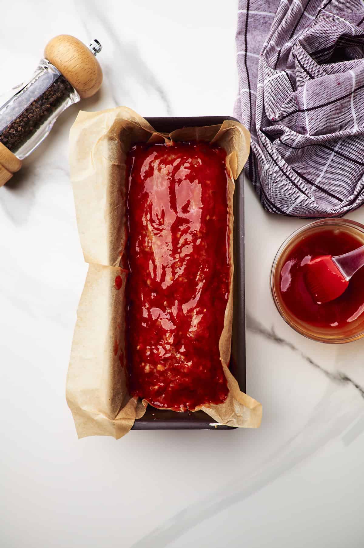 meatloaf with ketchup in baking dish.