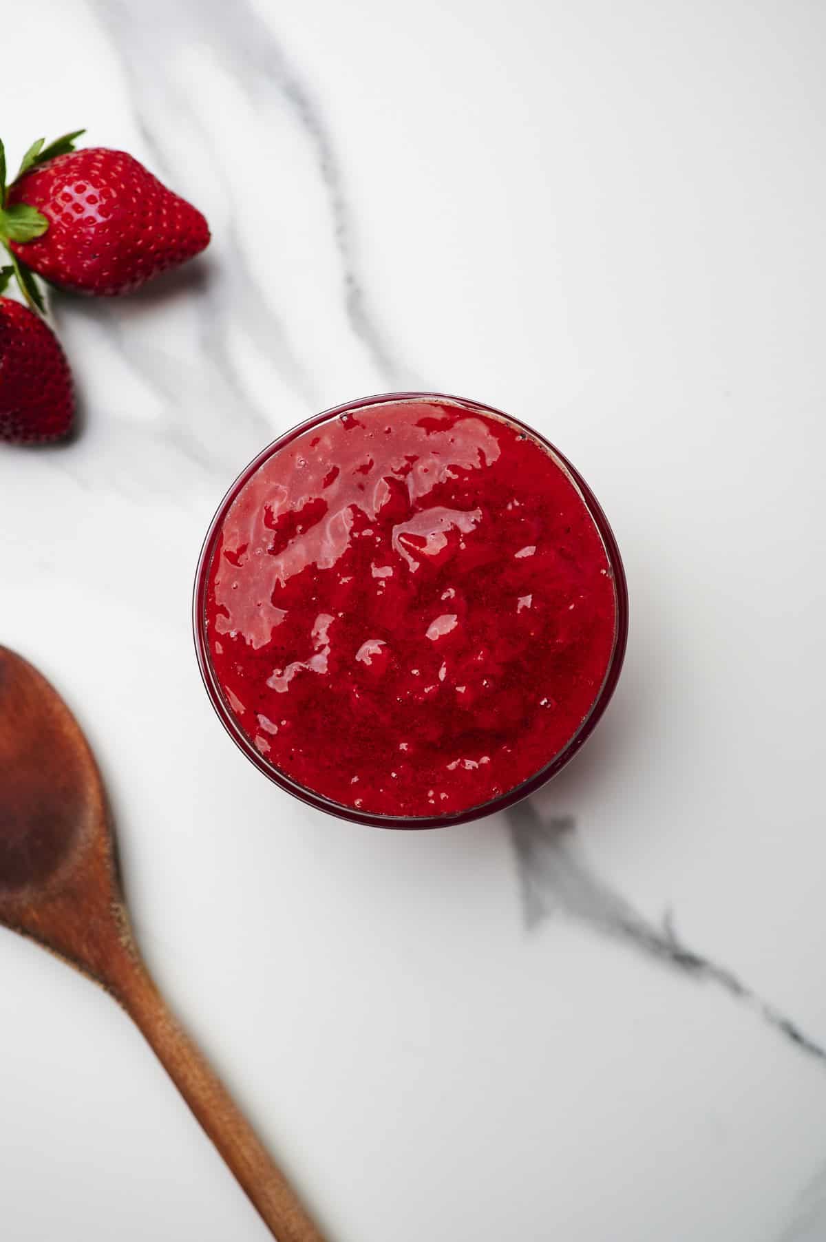 strawberry cake filling in bowl on countertop.