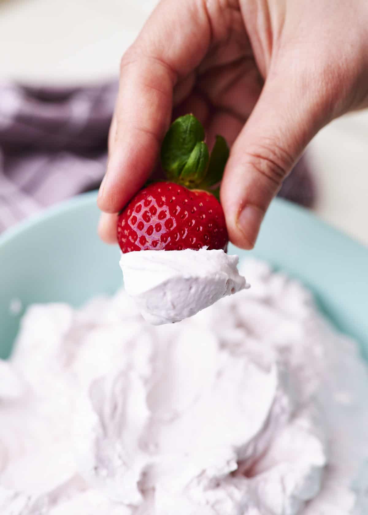 Strawberry dipped in whipped cream.