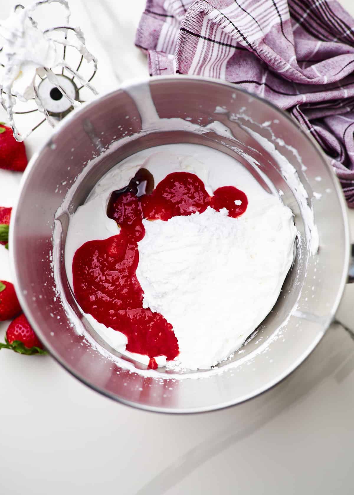 whipped cream with powdered sugar, strawberry puree and vanilla added.