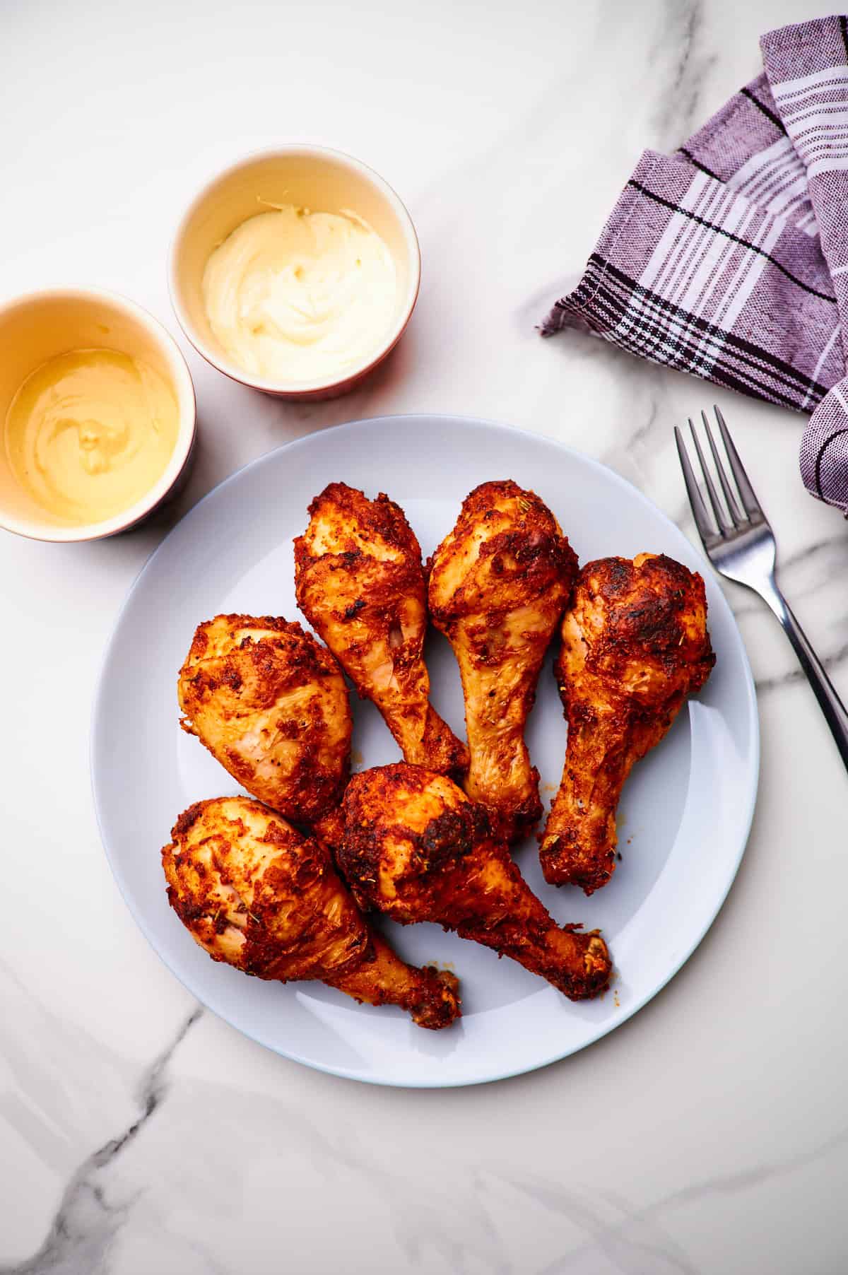 Plate of crispy chicken drumsticks.
