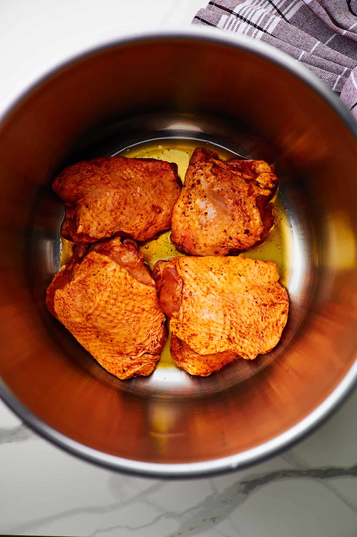 Turmeric Chicken searing in pan on stovetop.