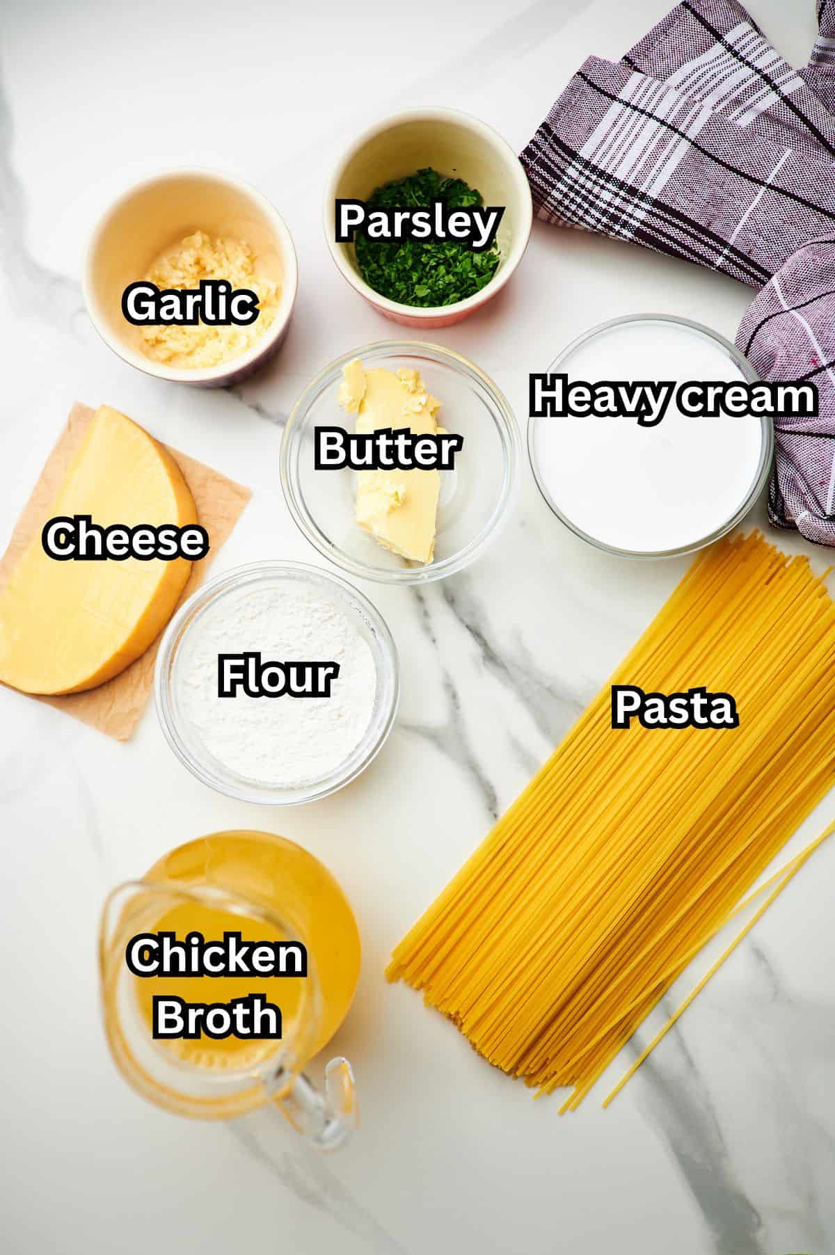 ingredients for creamy garlic pasta in prep bowls