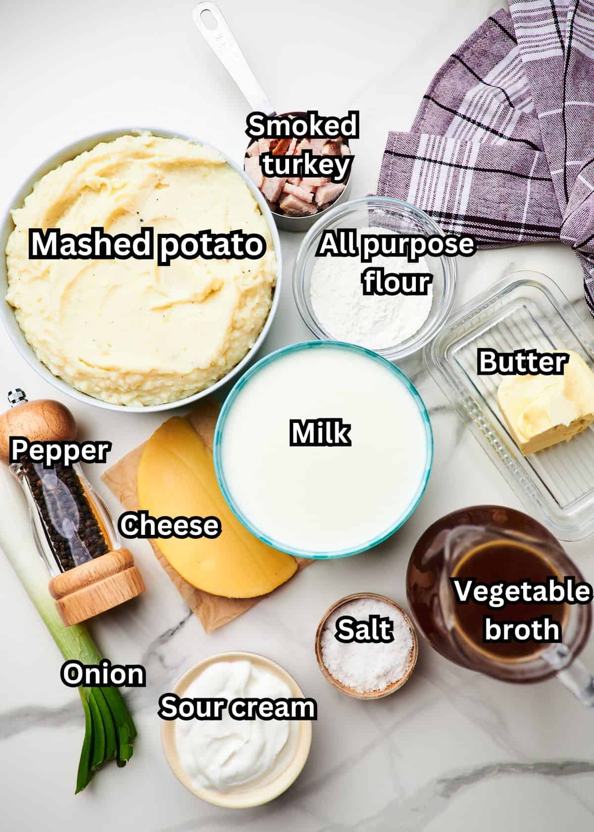 Ingredients for this soup on a white background with each one labeled in text with the name of it. 