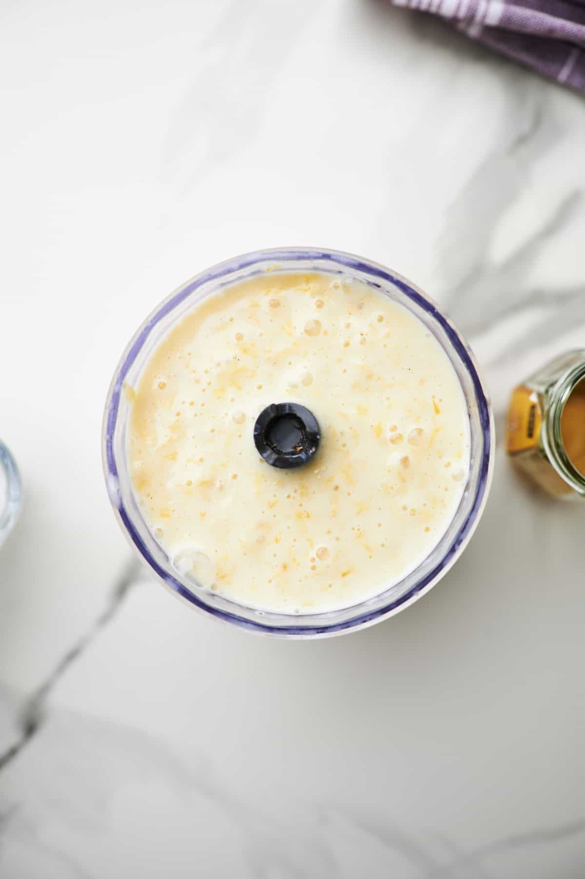 blended orange fruit smoothie in a blender