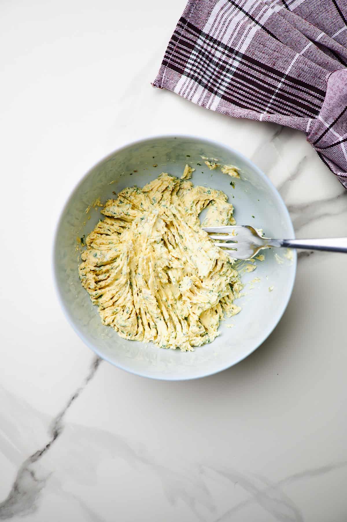 butter in bowl with garlic butter seasoning mixed in.