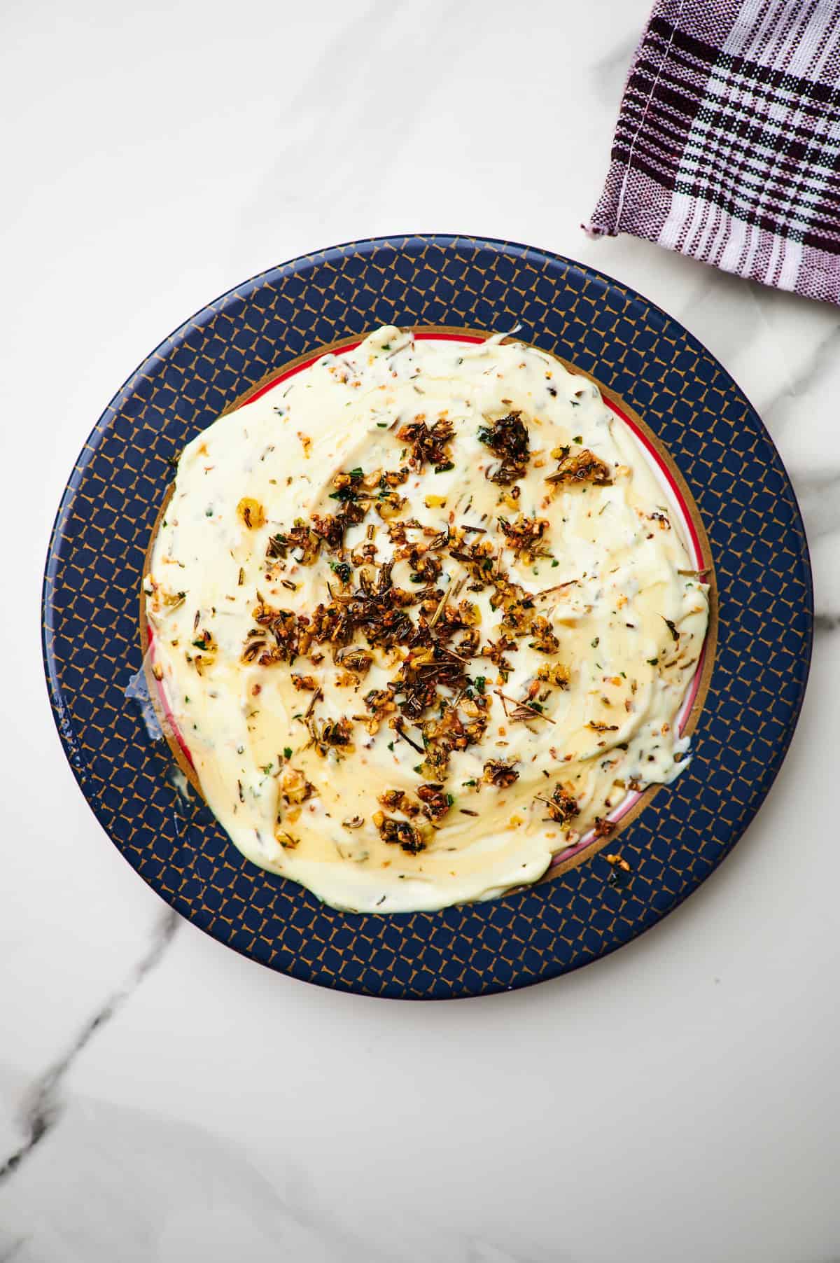 brie spread topped with honey, garlic, and herbs