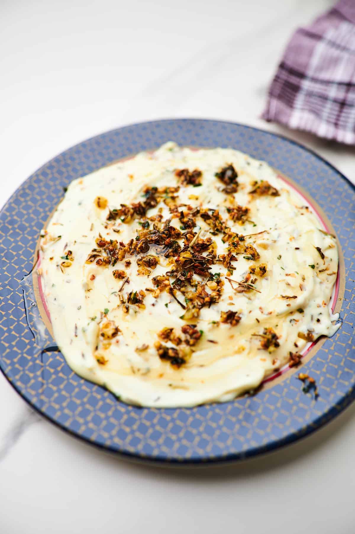 brie cheese spread topped with garlic butter herbs and honey