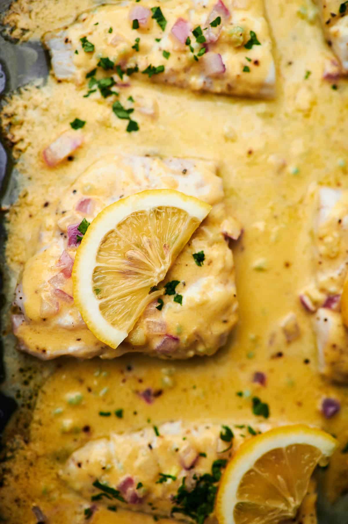 Overhead photo of Baked Fish with Lemon Cream Sauce on a plate