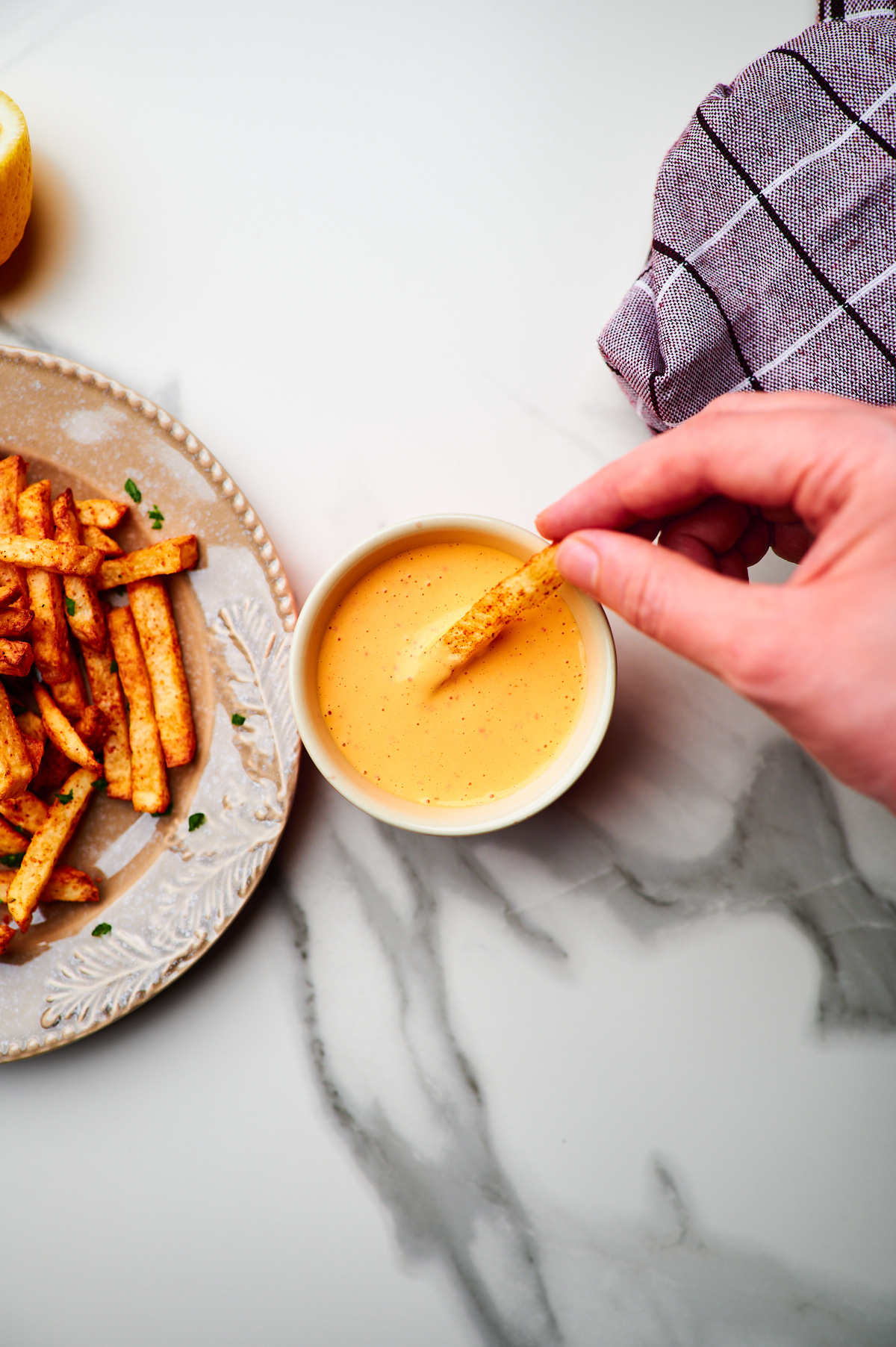 Dipping sweet potato fries in chipotle sauce