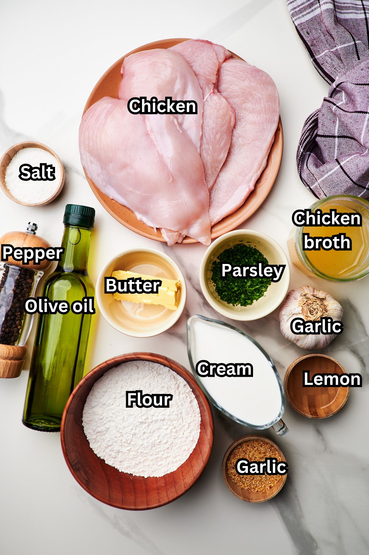 ingredients for creamy garlic chicken on a marble countertop