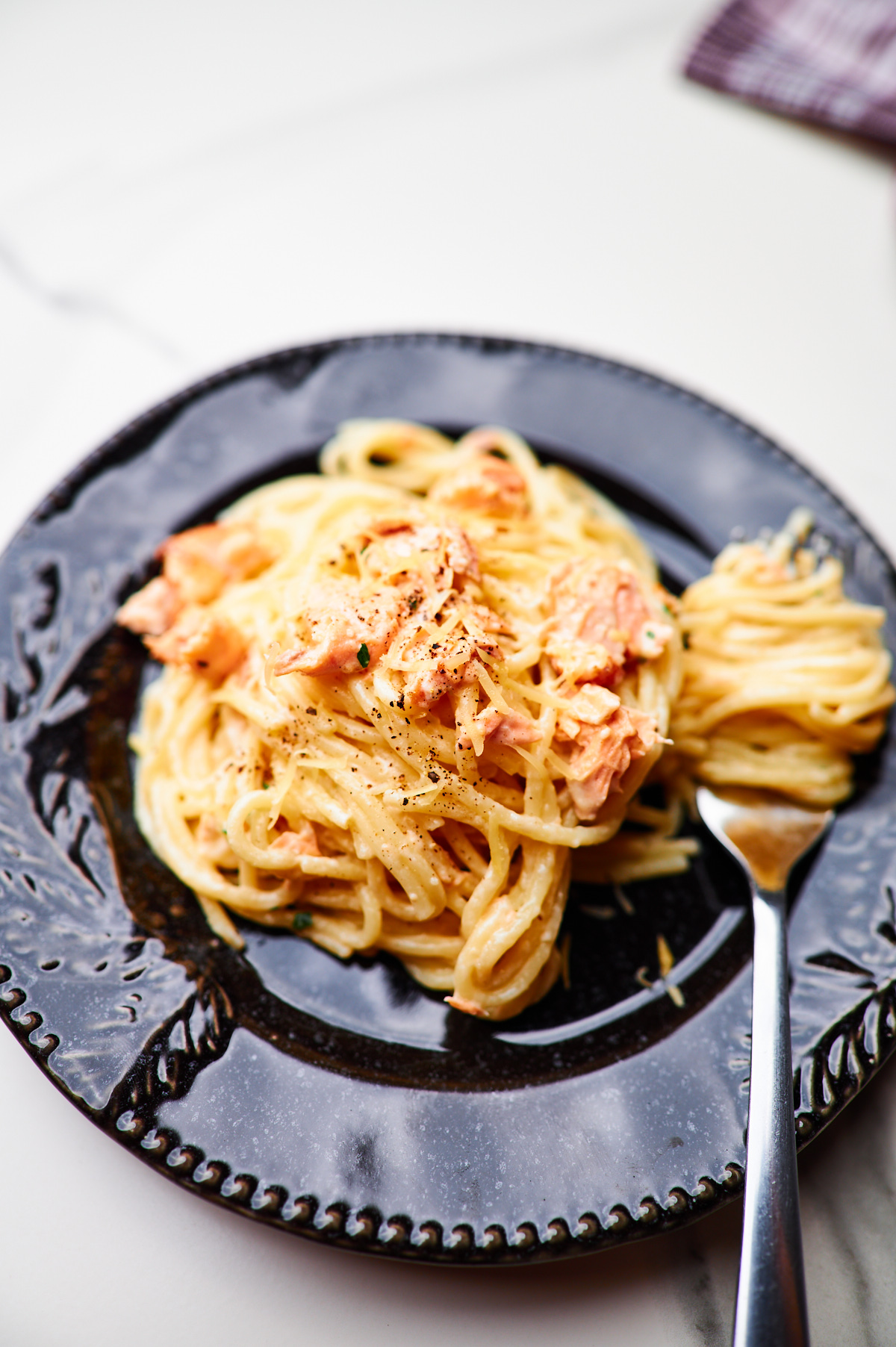 close-up of a plate of creamy garlic salmon pasta